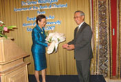 Dr. Tarisa Watanagase receiving a bouquet of flowers