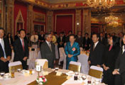 Attendees gather around Dr. Tarisa Watanagase at the party